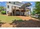 View of the backyard featuring a deck with stairs, a covered patio, and a wood fence at 5605 Miners Rdg, Cumming, GA 30028
