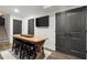 Entertainment area with a rustic wooden bar table, stools, and double doors at 5605 Miners Rdg, Cumming, GA 30028