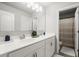 Bathroom features dual sinks, white cabinets, and a mirror with modern lighting at 5605 Miners Rdg, Cumming, GA 30028
