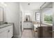 Modern bathroom features dual vanities, soaking tub, and glass-enclosed shower, offering a luxurious spa experience at 5605 Miners Rdg, Cumming, GA 30028