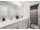 Bright bathroom with double sinks, white cabinets, and access to the shower at 5605 Miners Rdg, Cumming, GA 30028