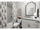 Cozy bathroom with patterned shower curtain, granite countertop and modern fixtures at 5605 Miners Rdg, Cumming, GA 30028