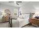 Inviting bedroom with natural light, a black metal bed frame, and wooden dressers at 5605 Miners Rdg, Cumming, GA 30028