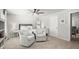 Bedroom area features a ceiling fan, neutral paint, and comfortable seating area at 5605 Miners Rdg, Cumming, GA 30028
