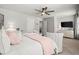 Spacious bedroom featuring a ceiling fan, plush bed, and seating area with windows at 5605 Miners Rdg, Cumming, GA 30028