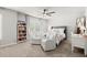 Bright bedroom featuring a bed, ceiling fan, and seating area with natural lighting at 5605 Miners Rdg, Cumming, GA 30028