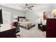 Comfortable bedroom with a ceiling fan, study desk, and a leather chair at 5605 Miners Rdg, Cumming, GA 30028