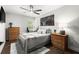 This bedroom offers comfort with modern ceiling fan and matching wood dressers at 5605 Miners Rdg, Cumming, GA 30028