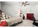 Cozy bedroom with ceiling fan, carpet, and red dresser, illuminated by lamps for a warm ambiance at 5605 Miners Rdg, Cumming, GA 30028