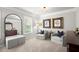 Relaxing bedroom featuring armchairs and wall art, creating a cozy seating area at 5605 Miners Rdg, Cumming, GA 30028