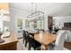Bright dining room with wood table, modern chandelier and outdoor access to porch at 5605 Miners Rdg, Cumming, GA 30028