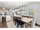 Dining room with wood table, designer chandelier, and modern finishes throughout at 5605 Miners Rdg, Cumming, GA 30028