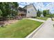 Side view of home with well-manicured lawn, wooden fence, and convenient driveway access at 5605 Miners Rdg, Cumming, GA 30028
