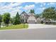 Inviting two-story home with a lush green lawn, a wide driveway, and a basketball hoop near the garage at 5605 Miners Rdg, Cumming, GA 30028