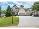 Attractive two-story home with a well-maintained lawn, basketball hoop, and a spacious driveway at 5605 Miners Rdg, Cumming, GA 30028