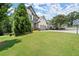 Charming two-story home with a lush green lawn, showcasing its inviting curb appeal at 5605 Miners Rdg, Cumming, GA 30028