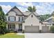 Beautiful two-story home featuring a brick facade, complemented by a well-kept lawn and a spacious driveway at 5605 Miners Rdg, Cumming, GA 30028