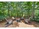 Backyard firepit area with four Adirondack chairs, offering a cozy outdoor gathering space at 5605 Miners Rdg, Cumming, GA 30028