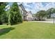A bright green lawn, a two-story home, driveway and garage with basketball hoop are the highlights of this property at 5605 Miners Rdg, Cumming, GA 30028