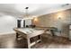 Spacious game room with a pool table, bar, and stylish brick wall at 5605 Miners Rdg, Cumming, GA 30028
