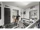 This home gym features mirrors, weights, and a Superfit treadmill with weights and door to pool table room at 5605 Miners Rdg, Cumming, GA 30028