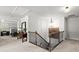 Upstairs hallway showcasing wood railing and an overlook into a well-lit bedroom at 5605 Miners Rdg, Cumming, GA 30028