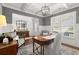 Bright and airy home office featuring plantation shutters and coffered ceiling at 5605 Miners Rdg, Cumming, GA 30028
