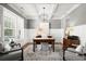 This office features a tray ceiling, plantation shutters, chair railing and handsome wood desk at 5605 Miners Rdg, Cumming, GA 30028