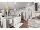 Bright kitchen features granite counters, stainless appliances and pendant lighting at 5605 Miners Rdg, Cumming, GA 30028