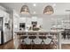 Bright kitchen with stainless fridge, granite island, and modern lighting at 5605 Miners Rdg, Cumming, GA 30028