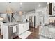 Open kitchen with granite island, stainless dishwasher, and hardwood floors at 5605 Miners Rdg, Cumming, GA 30028