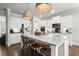 Open-concept kitchen with a large island, stainless steel appliances, and ample cabinet space at 5605 Miners Rdg, Cumming, GA 30028