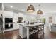 Stylish kitchen with stainless appliances, granite island, and pendant lights at 5605 Miners Rdg, Cumming, GA 30028