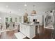 Open-concept kitchen flows into the living area, featuring a large island and modern fixtures at 5605 Miners Rdg, Cumming, GA 30028