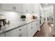 Bright kitchen with white cabinets, granite countertops, and modern appliances at 5605 Miners Rdg, Cumming, GA 30028