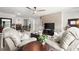 Upstairs living room features a ceiling fan, a decorative wall, and comfortable seating at 5605 Miners Rdg, Cumming, GA 30028