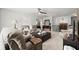 Cozy second-floor living room with a ceiling fan, plush seating, and access to the staircase at 5605 Miners Rdg, Cumming, GA 30028