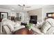 Open living area with plank accent wall, modern ceiling fan, large windows, and comfortable seating at 5605 Miners Rdg, Cumming, GA 30028