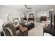 Inviting living area features a ceiling fan, plush seating, and open space for relaxation and entertainment at 5605 Miners Rdg, Cumming, GA 30028