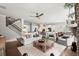 Open concept living space with hardwood floors, fireplace, kitchen, and stairs at 5605 Miners Rdg, Cumming, GA 30028