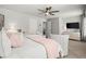 Main bedroom boasts a ceiling fan, plush bedding, and a bright, airy atmosphere for comfortable living at 5605 Miners Rdg, Cumming, GA 30028