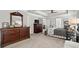 Expansive primary suite showcasing a large dresser and a glimpse into the sleeping area at 5605 Miners Rdg, Cumming, GA 30028