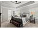Comfortable primary bedroom with a ceiling fan and a dark wood bench at 5605 Miners Rdg, Cumming, GA 30028