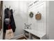 Inviting mudroom area with coat rack, bench with storage, and stylish decorative accents at 5605 Miners Rdg, Cumming, GA 30028