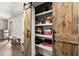 Organized pantry with sliding barn doors and ample shelving for storage and games at 5605 Miners Rdg, Cumming, GA 30028