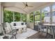 This screened-in porch features comfortable seating, a ceiling fan, and views of the lush backyard at 5605 Miners Rdg, Cumming, GA 30028