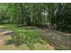 Backyard featuring a large lawn and mature trees at 1050 Chapman Circle Cir, Stone Mountain, GA 30088