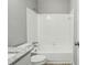 Bright bathroom featuring white tiled walls surrounding the tub and shower combo at 1050 Chapman Circle Cir, Stone Mountain, GA 30088