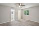 Carpeted bedroom featuring a ceiling fan, window, and doorways to a bathroom and closet at 1050 Chapman Circle Cir, Stone Mountain, GA 30088