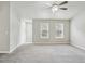 Spacious bedroom with neutral paint, plush carpet, and natural lighting from two windows at 1050 Chapman Circle Cir, Stone Mountain, GA 30088